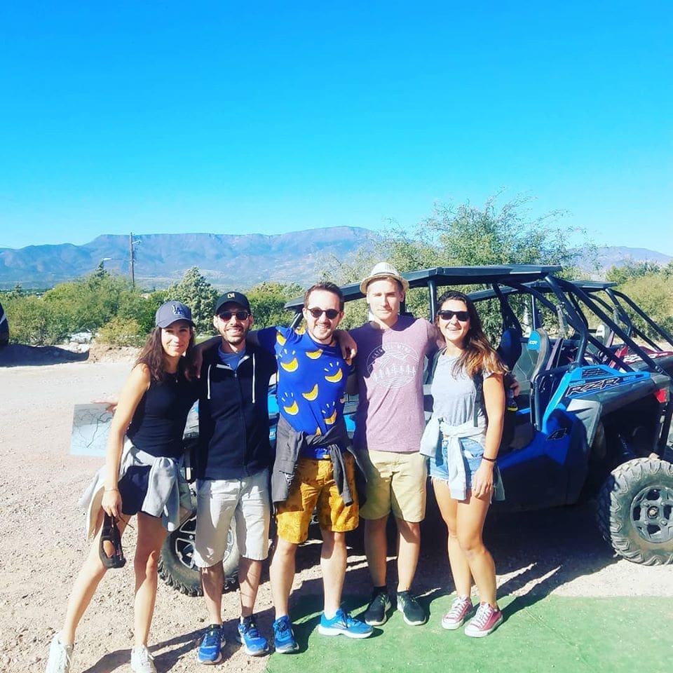 Group of renters posing before their ATV rental through Sedona Arizona