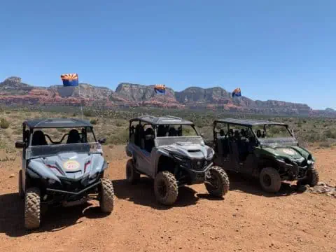 2-seater, 4-seater, and 6-seater off-road vehicles in front of Sedona Red Rocks
