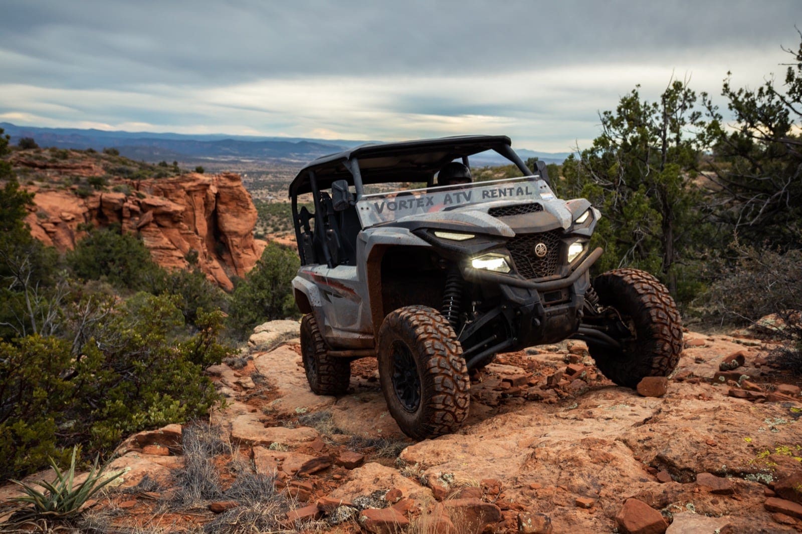 4-seater UTV Rental rock crawling in a red beautiful canyon