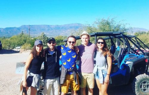 Group of renters posing before their ATV rental through Sedona Arizona