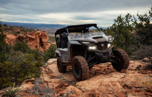 4-seater UTV Rental rock crawling in a red beautiful canyon